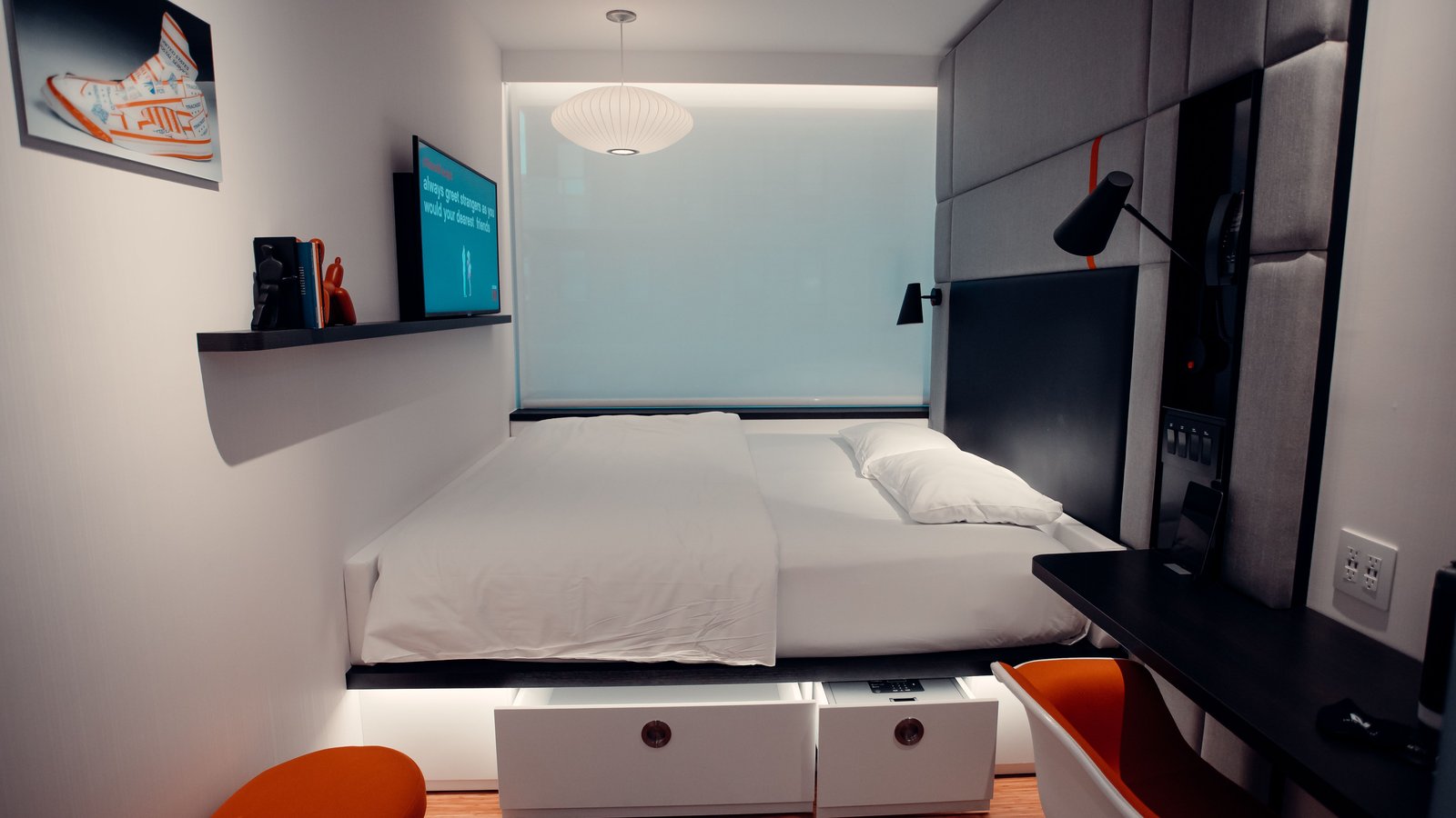 Modern bedroom with white bed and under-bed drawers — atmosphere, not a product pick
