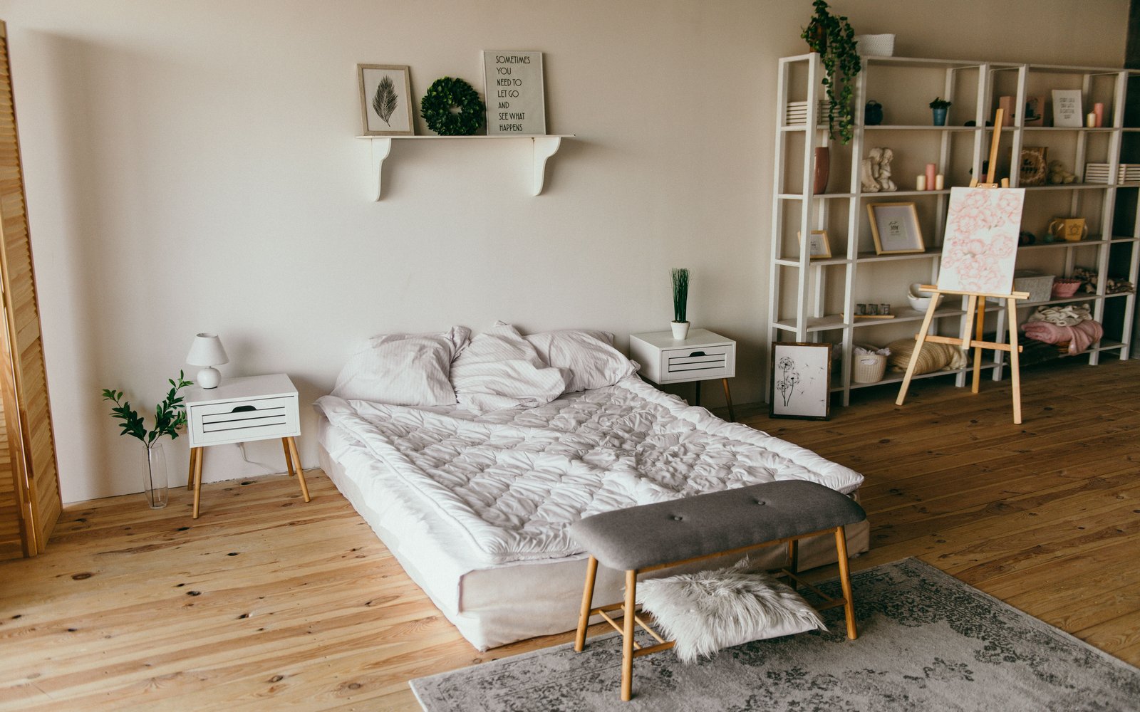 Low modern bed with shelf storage nearby — atmosphere, not a CleverMade listing photo