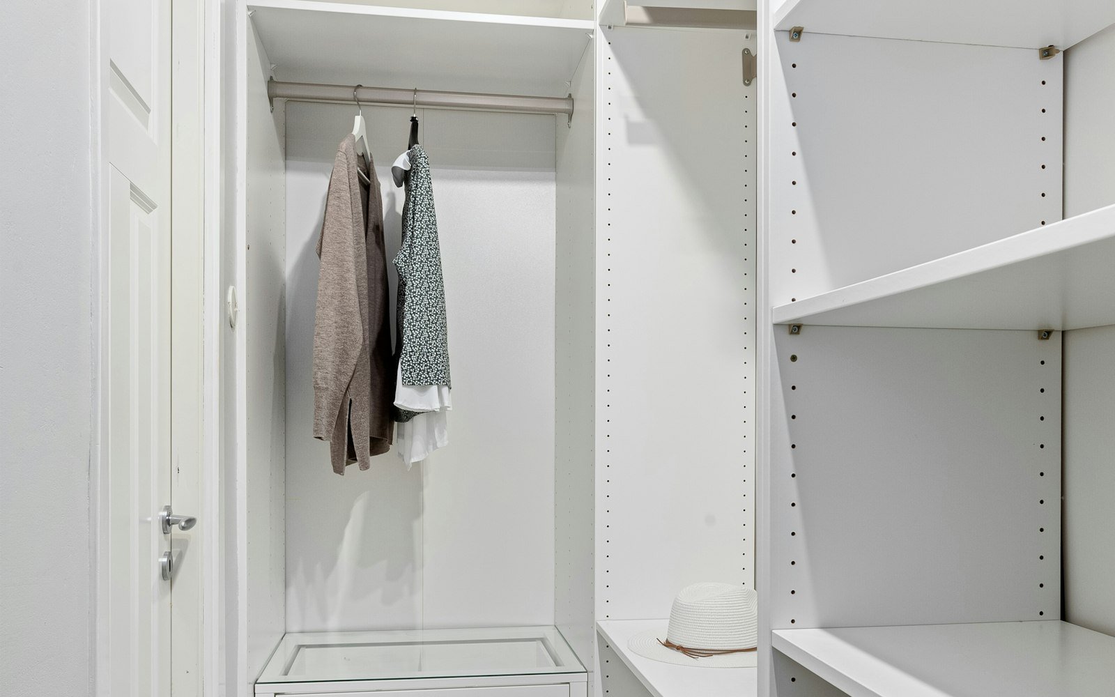 Walk-in closet with white shelving — atmosphere, not a product pick