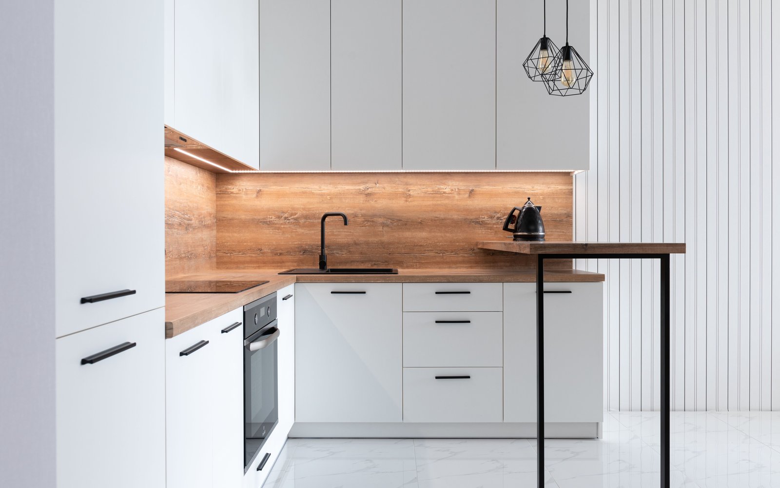 White L-shaped kitchen with a wood backsplash and a narrow breakfast ledge, atmosphere photo, not a listing photo of any pick