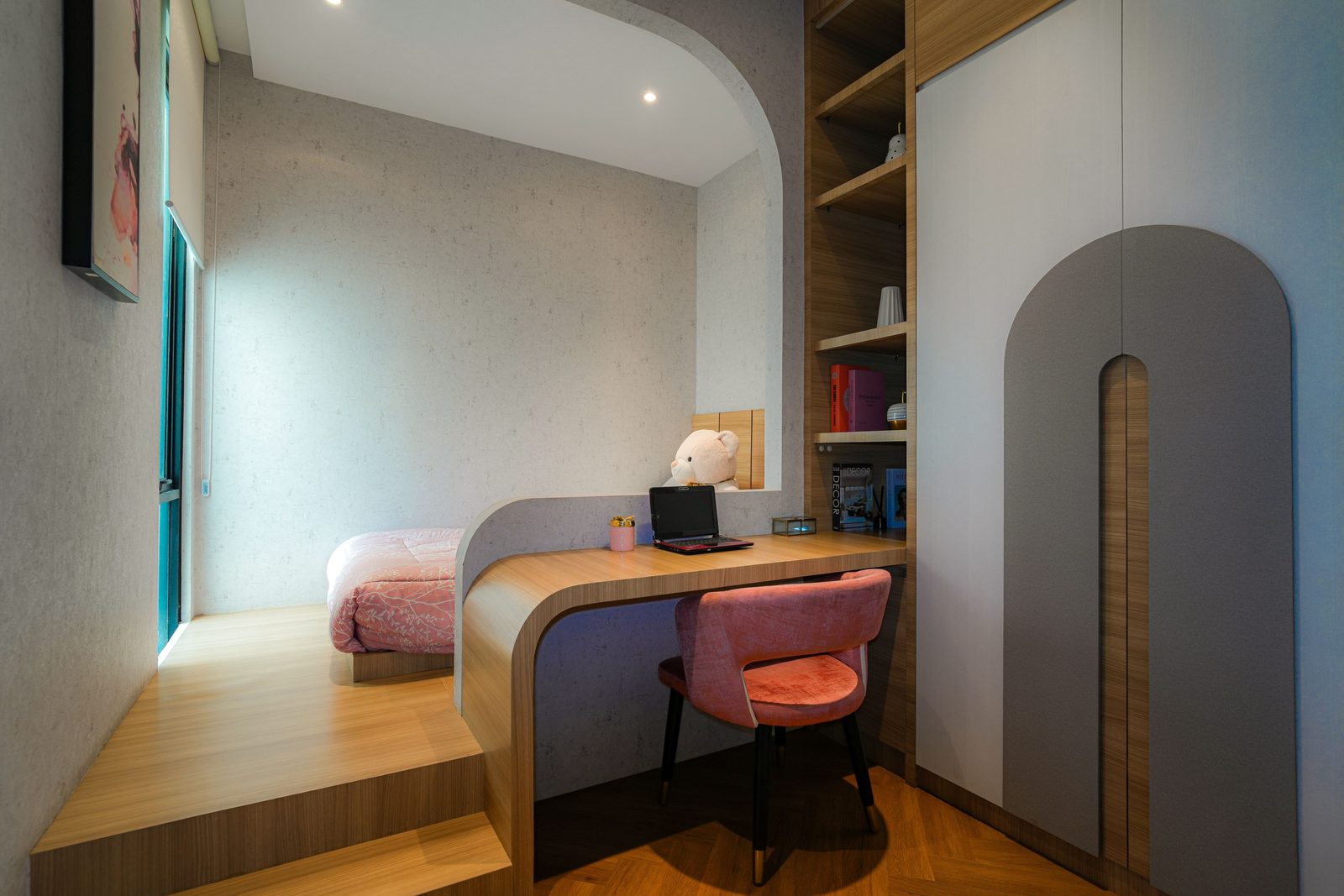 Bedroom workspace with a wooden desk, chair and shelves next to the bed